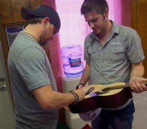 Jason Aldean signing a guitar... Mike actually being useful